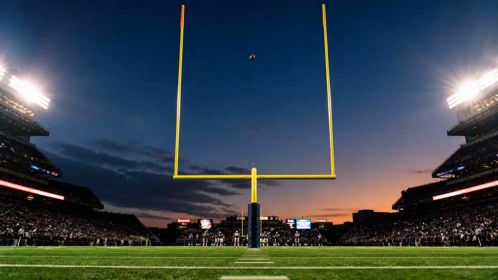 Close-up view of an American football field goal attempt during an NFL game with goalposts and green turf visible